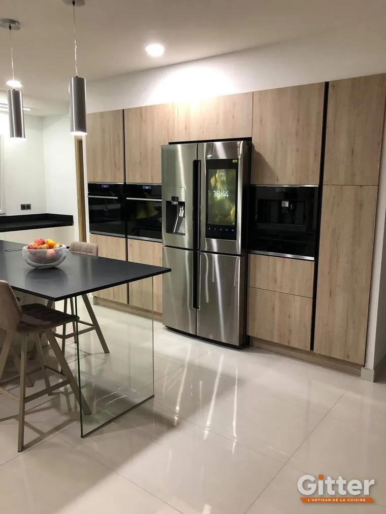 Cuisine avec colonnes bois, réfrigérateur américain et table haute, réalisation Gitter à Augny