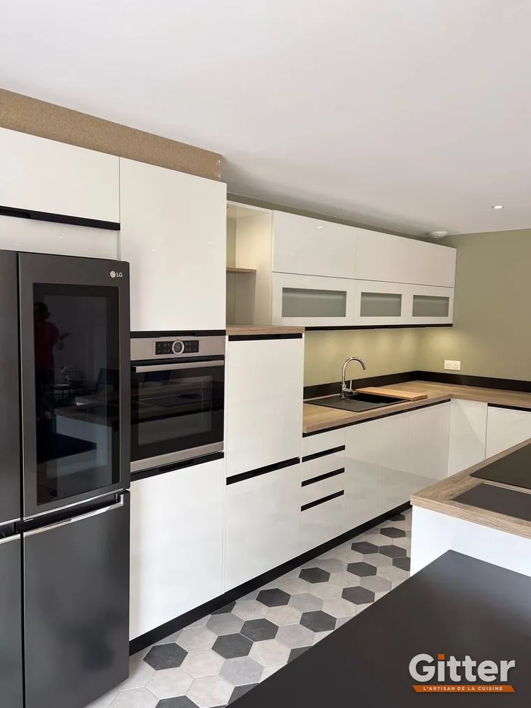 Cuisine : façades blanches, colonnes four et plan de travail bois, sol hexagonal, réalisation Gitter à Yutz